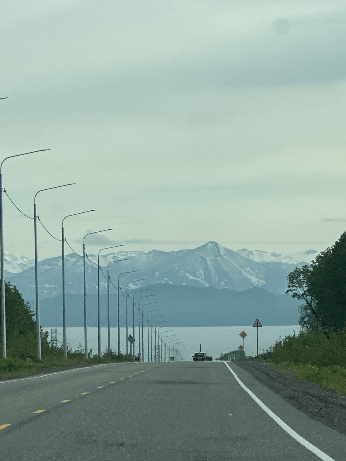 Morning drive through Petropavlovsk-Kamchatsky toward snow-capped peaks