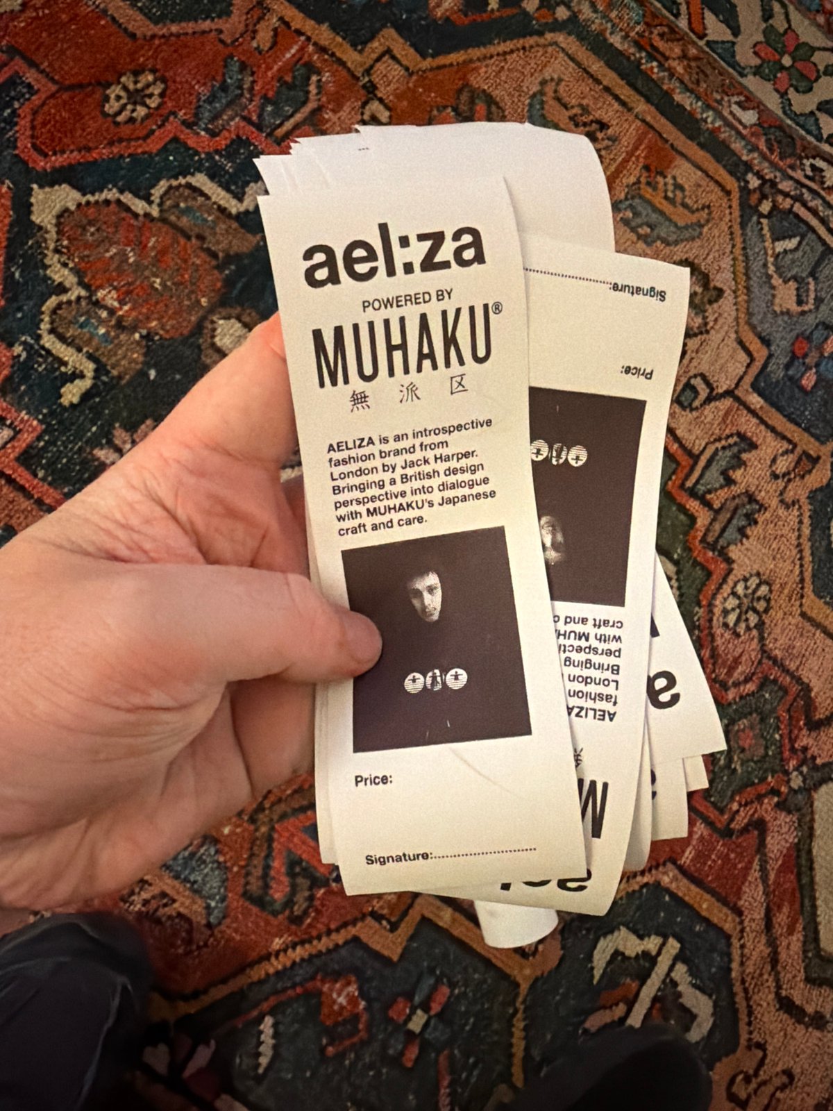 Person holds mysterious white tags with face symbols in NYC