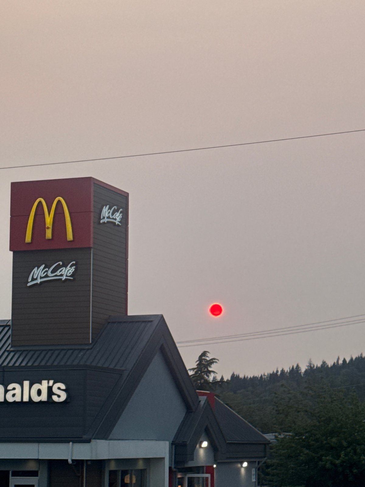 Wildfire smoke turns Coquitlam skies red over urban streets