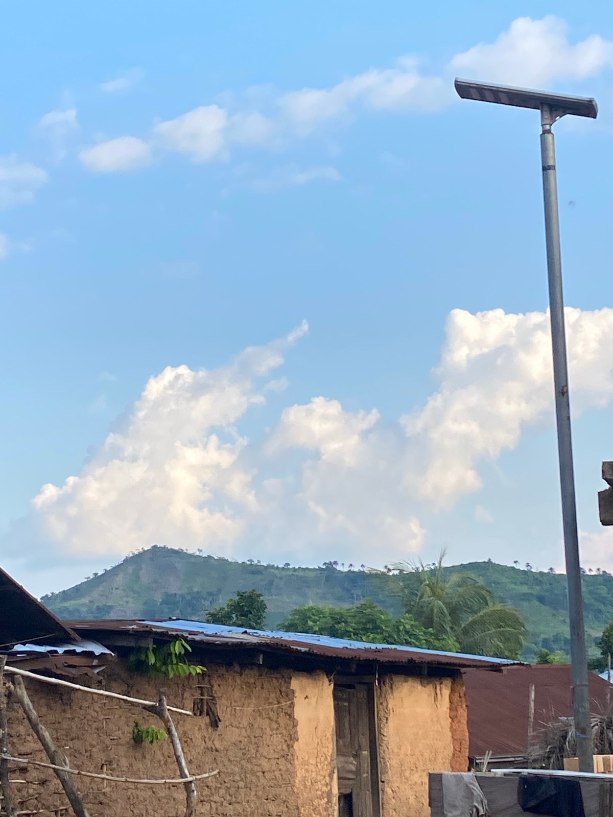 Rural Igbara: mud-brick homes and hills in late afternoon light