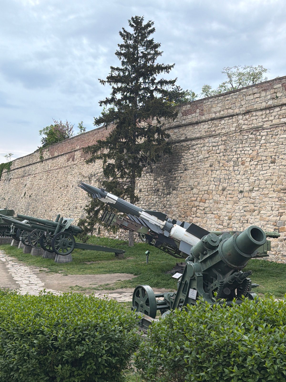 Tourist visits Belgrade Fortress military museum on overcast afternoon