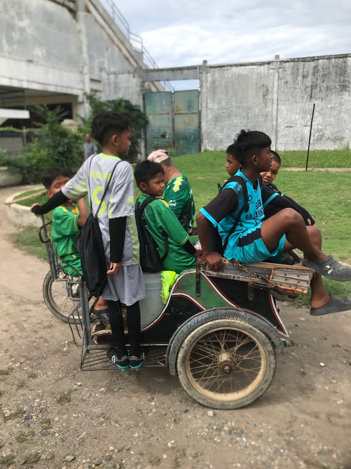 Four youths share modified bicycle with sidecar in Lhokseumawe