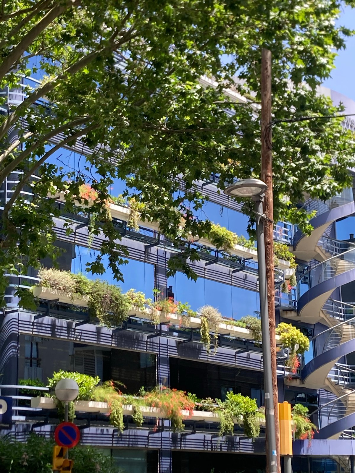 Barcelona office building with spiral staircase and vertical gardens