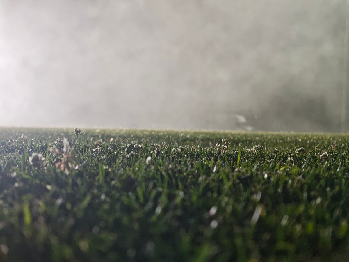 Foggy night soccer on a Tbilisi pitch under floodlights