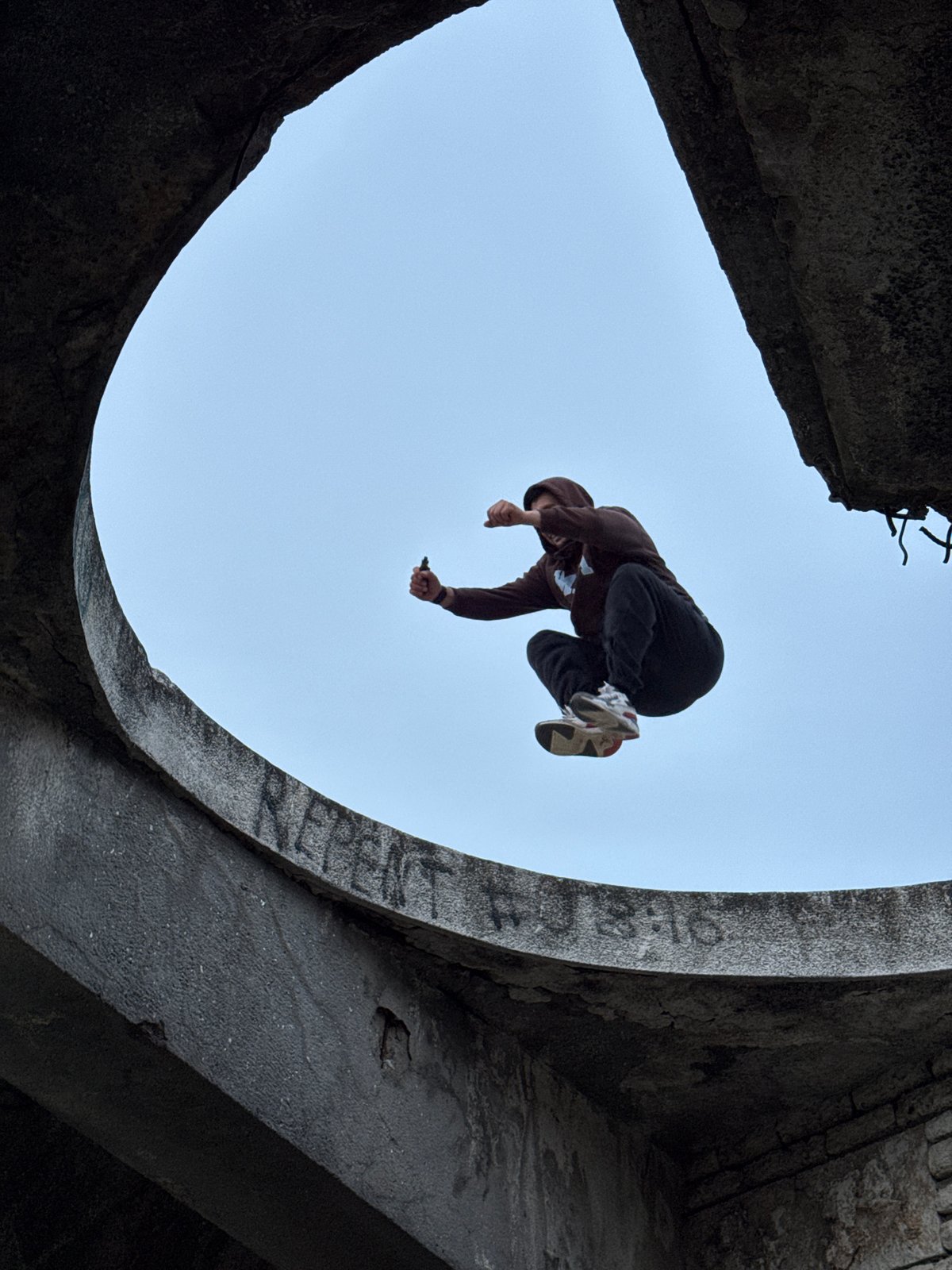 Parkour performance captured at graffitied concrete structure in Varna