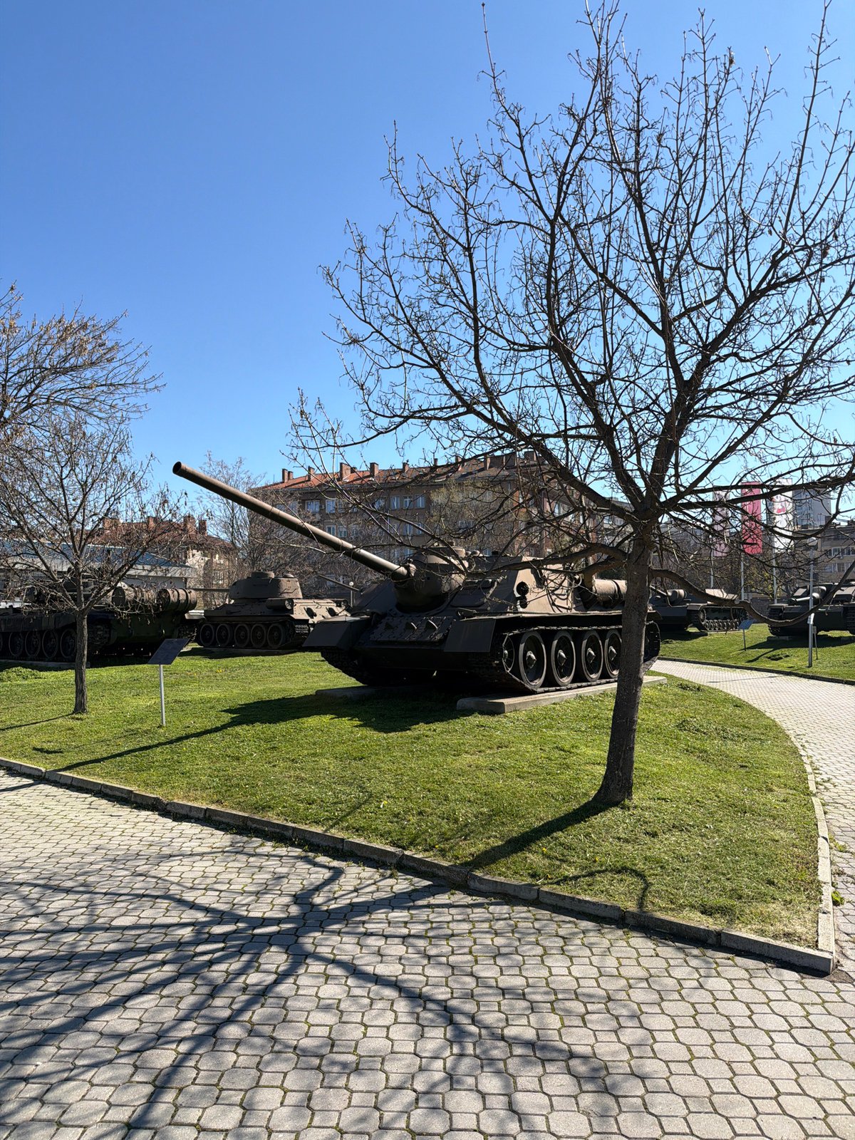 Military museum displays tanks and fighter jet outdoors