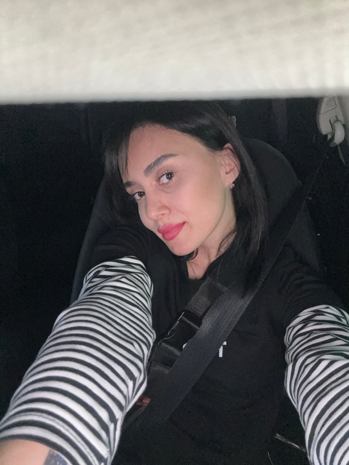 Woman photographed in car passenger seat in Tbilisi