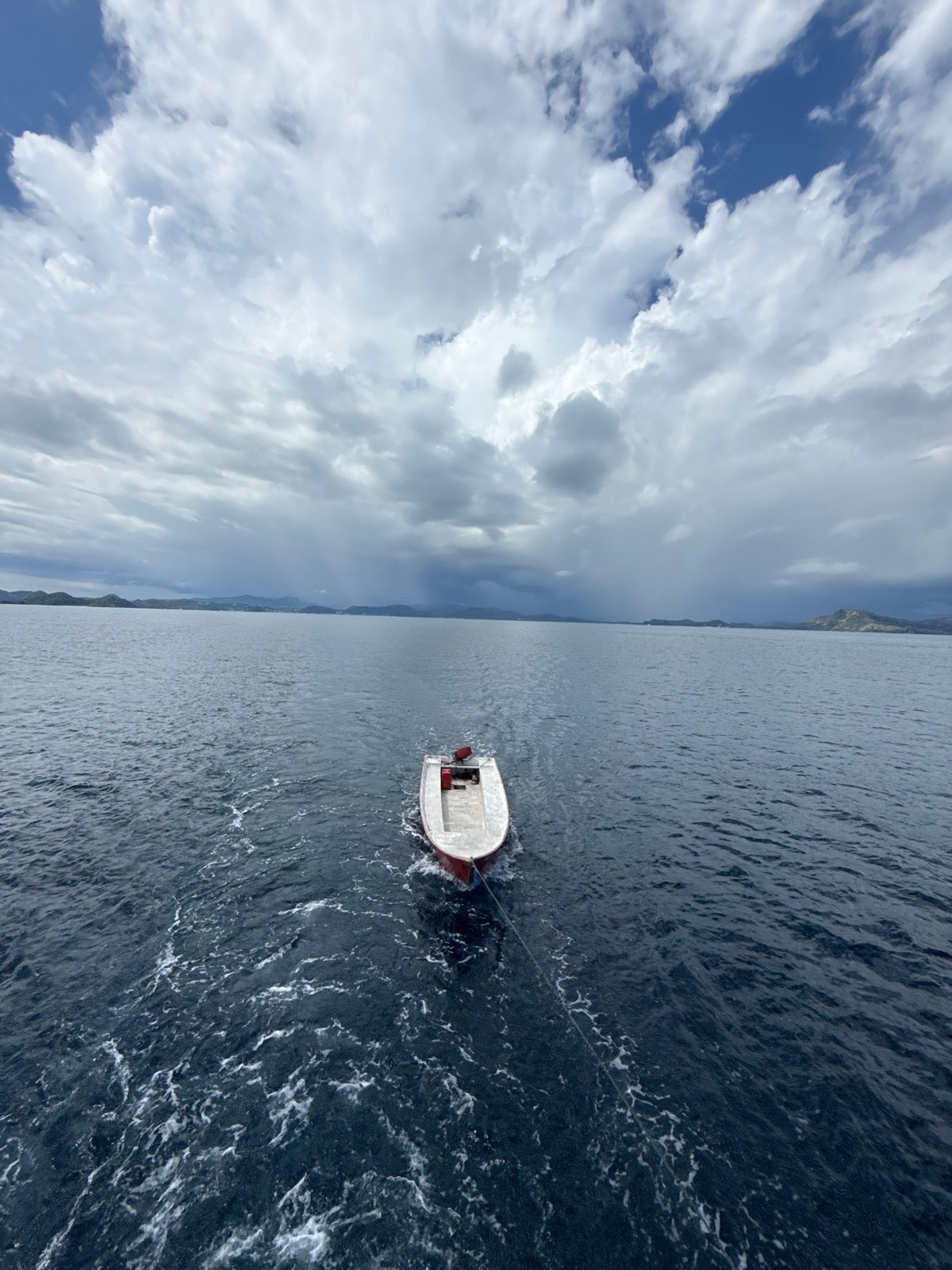 Motorboat towed across choppy waters near Pasir Putih, Indonesia