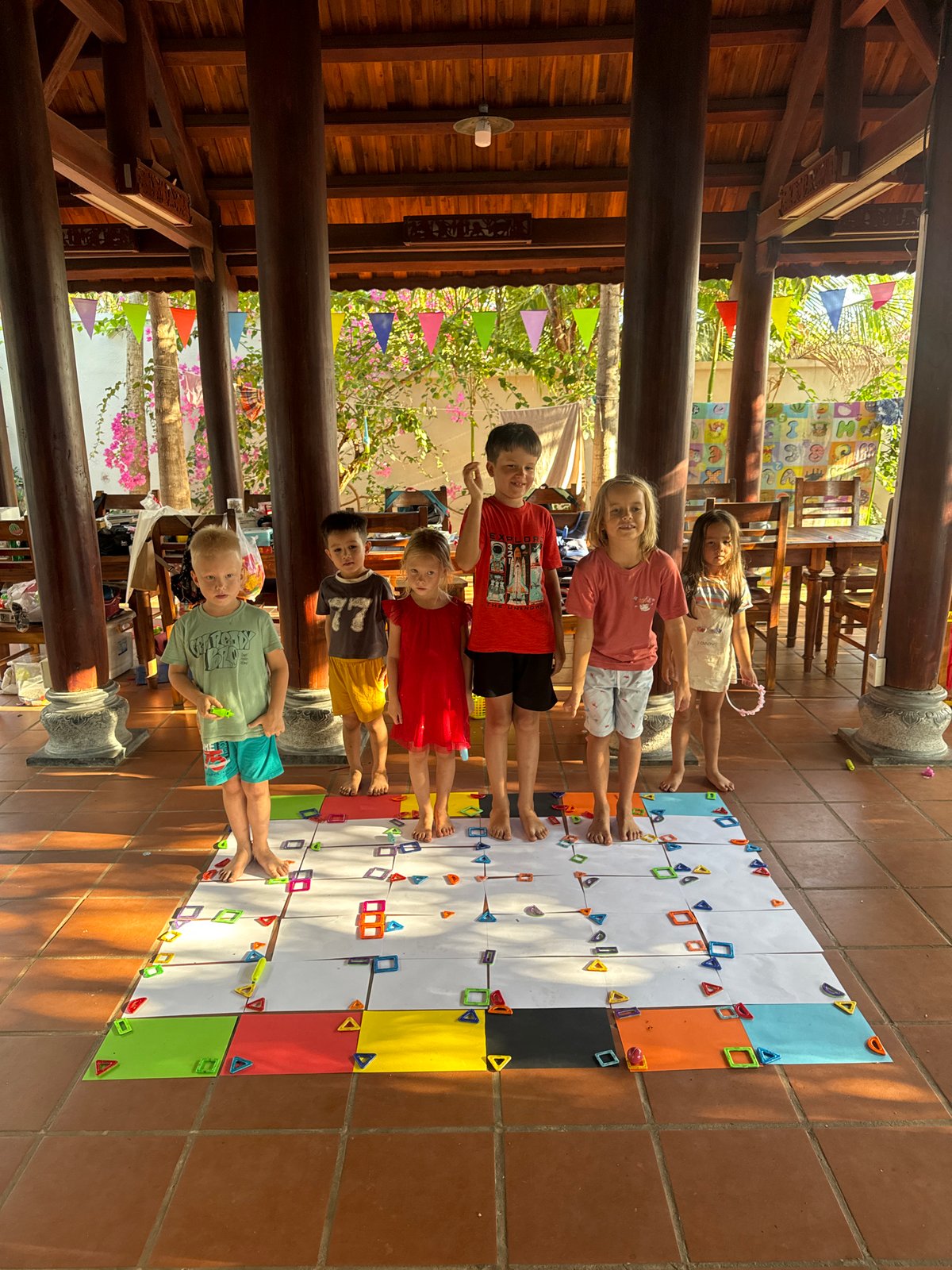 Children play floor game in Vietnamese pavilion
