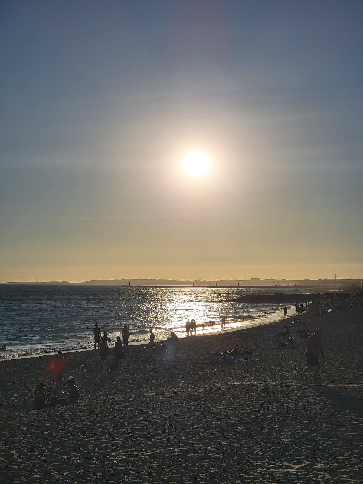 Late afternoon at Quarteira beach, phones out by the water