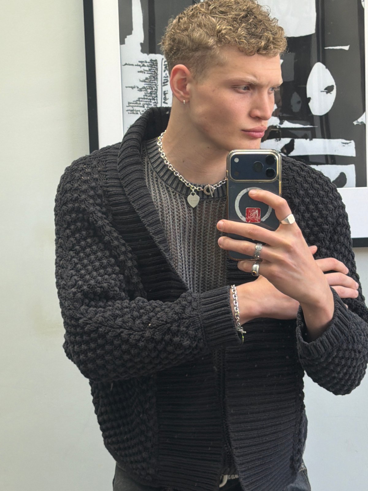 Young man takes selfies at London art venue