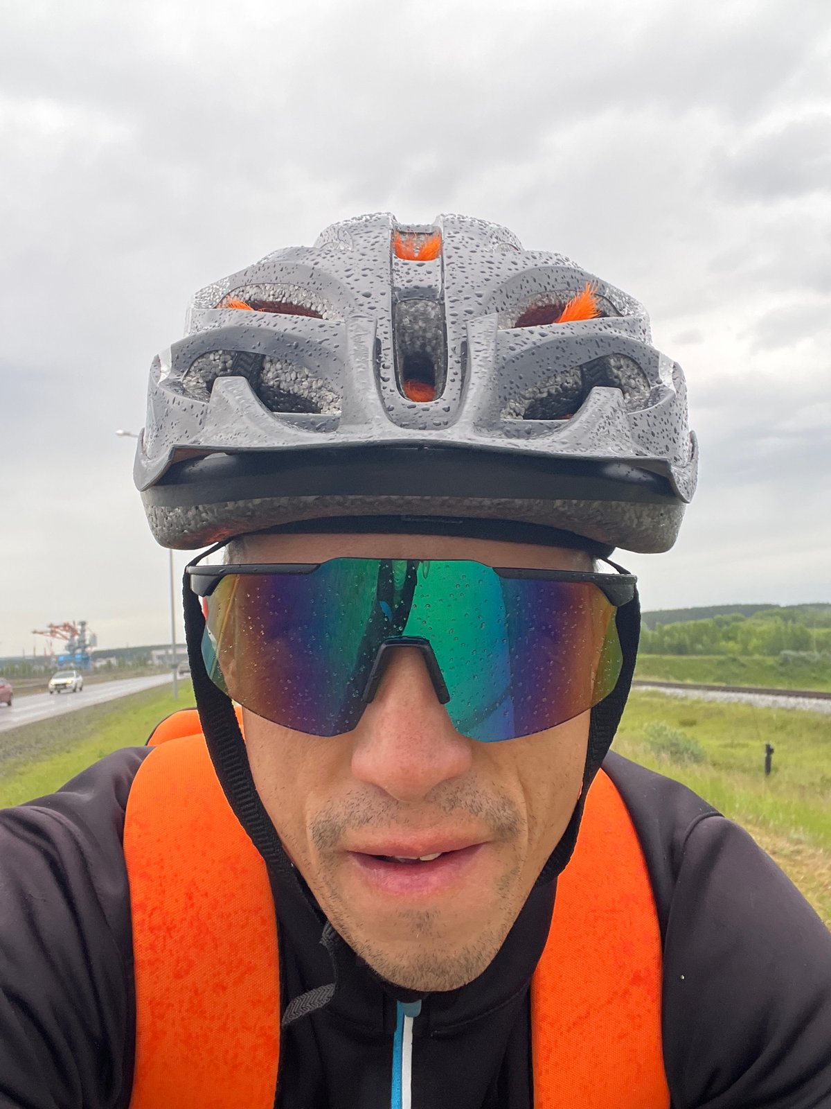 Cyclist photographed in rainy conditions in Chaikovsky, Russia