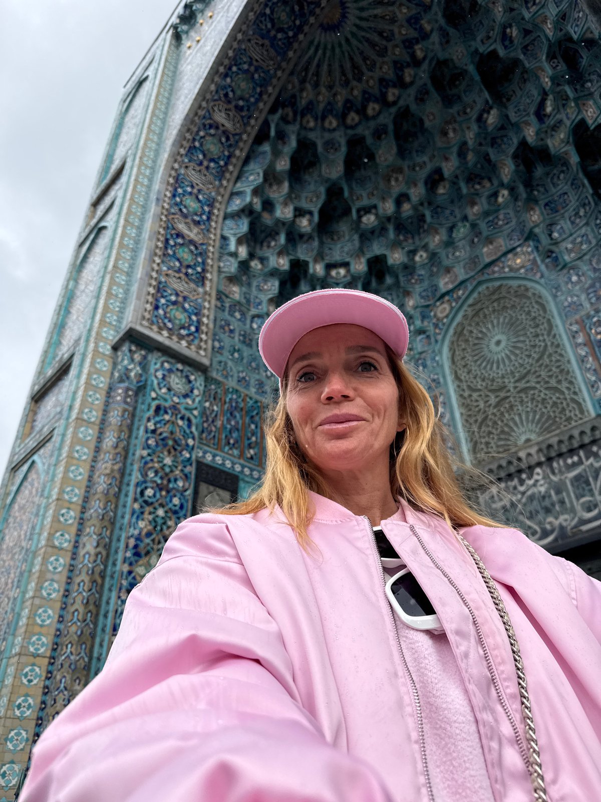 Tourist visits Saint Petersburg Mosque during rainy May morning