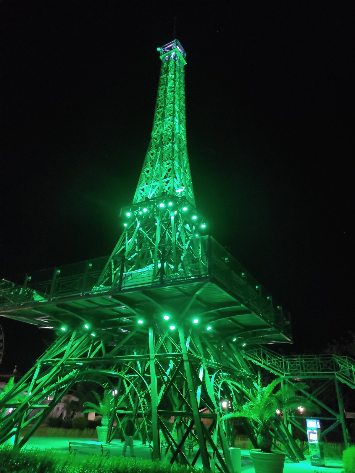 Illuminated Eiffel Tower replica observed at night attraction