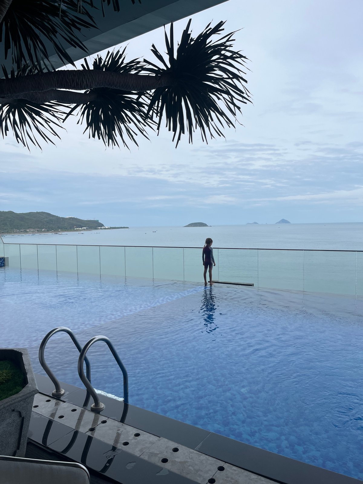 Infinity pool overlooking bay photographed at Vietnam resort