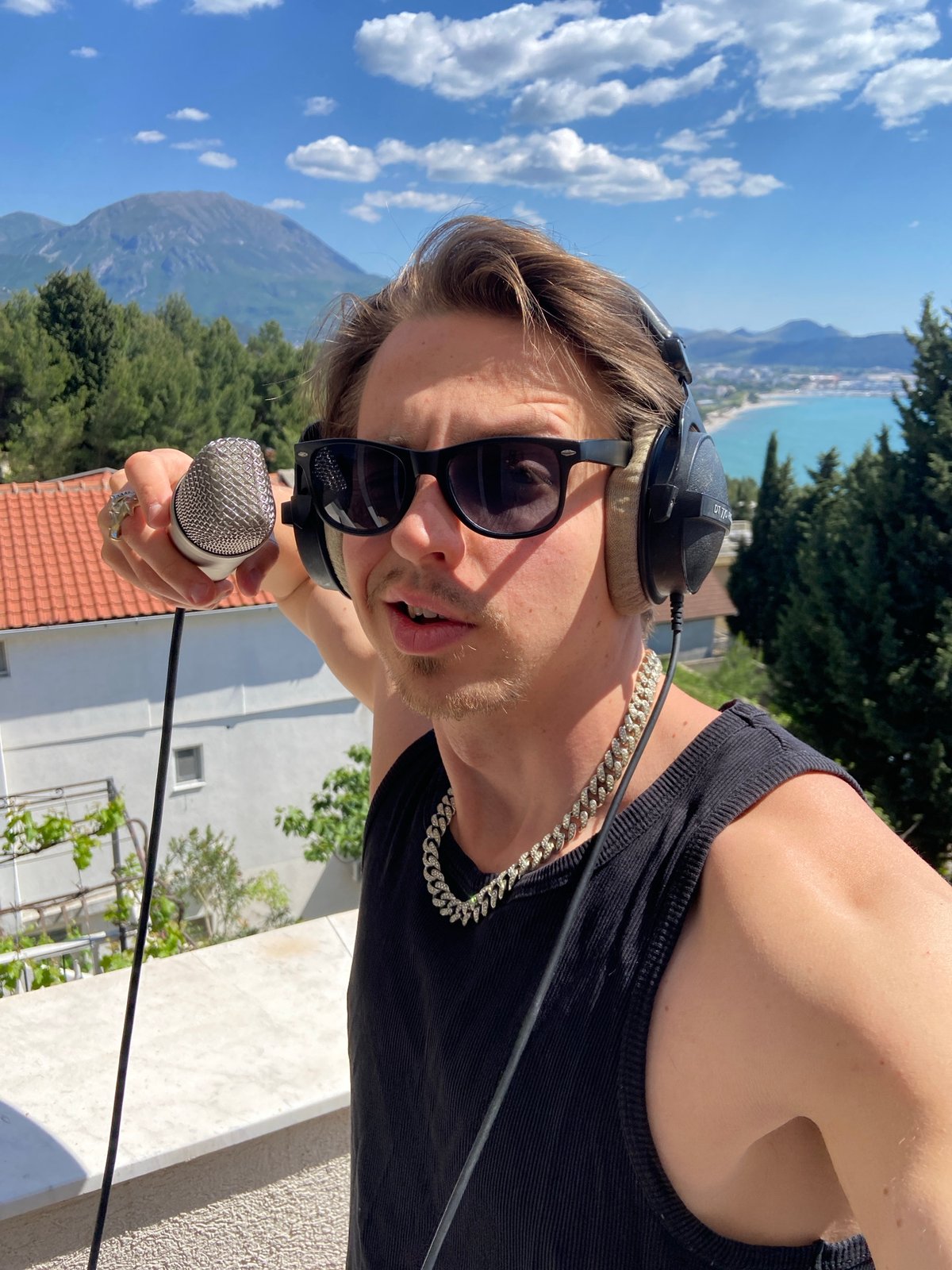 Young man poses for photos on Montenegro balcony