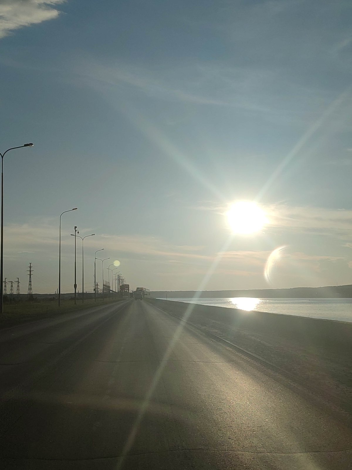 Driver documents sunny road journey with celestial sightings