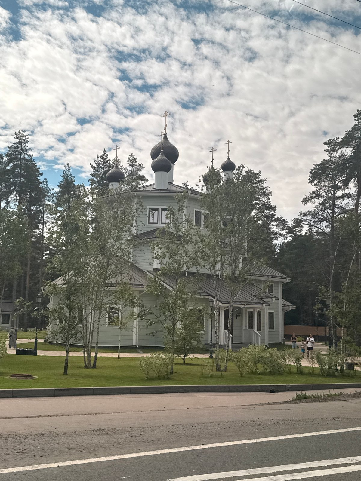 Green Orthodox church with onion domes in Solnechnoye, Russia