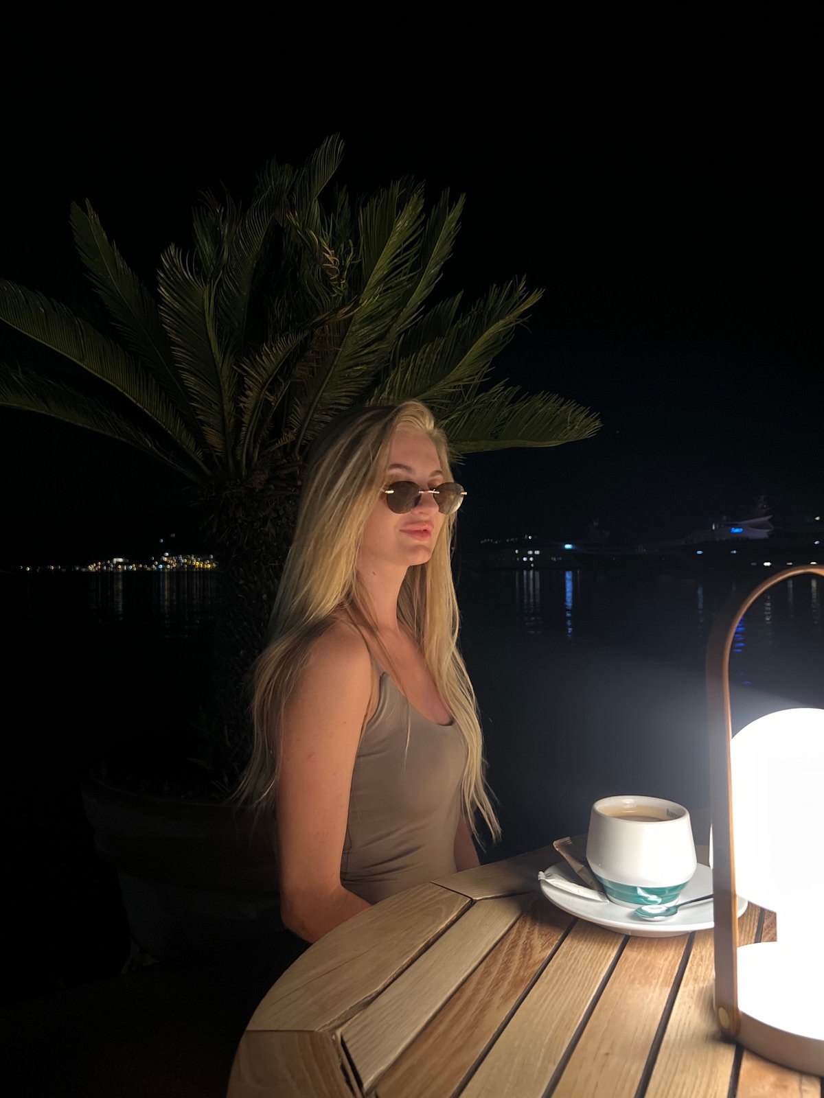 Women enjoy evening coffee at outdoor café in Tivat
