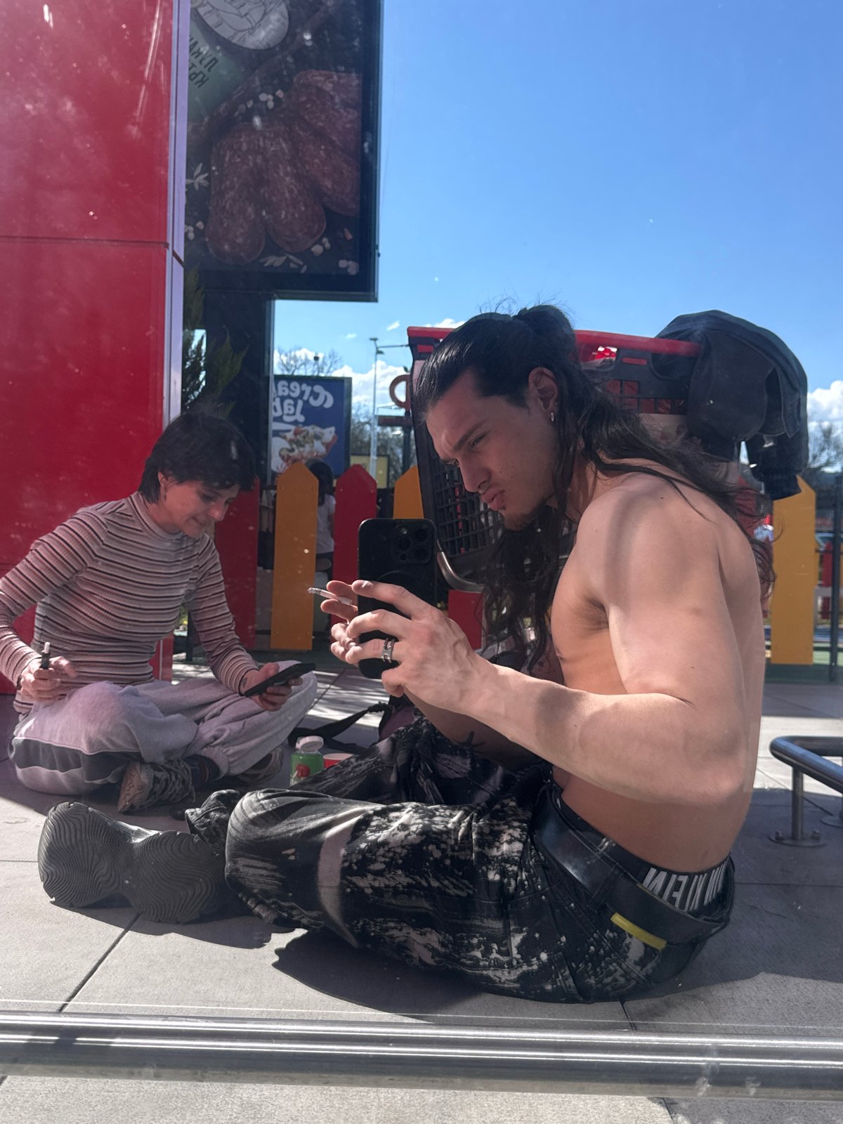 Person photographed smoking, using phone in Sofia