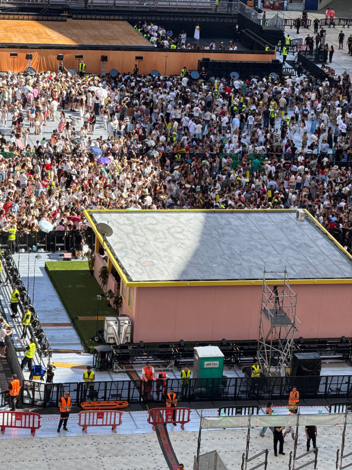 Thousands gather at outdoor stadium event under clear skies