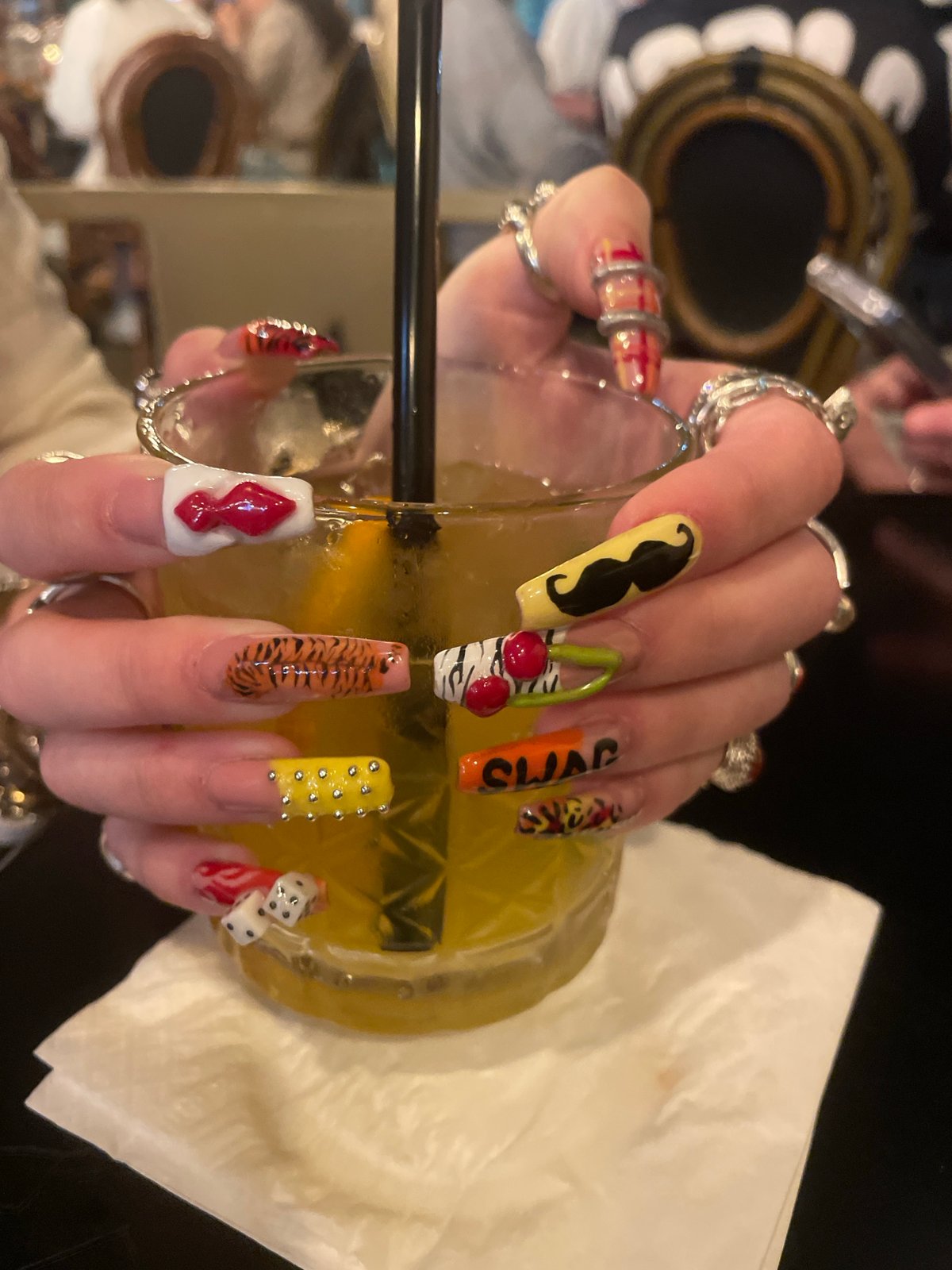 Woman shows off mustache nail art at Raanana restaurant
