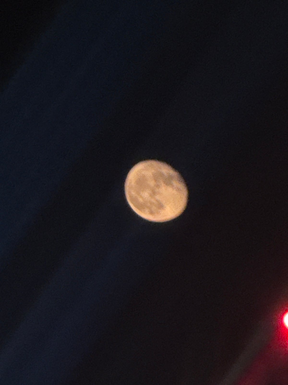 Moon photographed with red light in Moscow evening sky