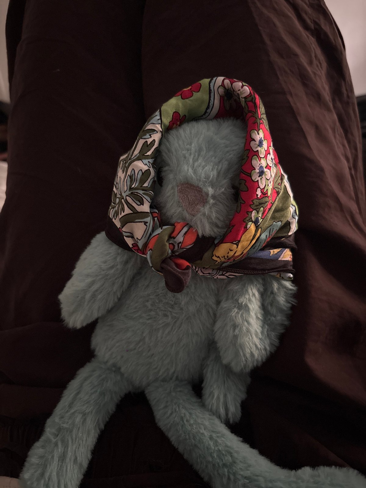 Blue stuffed rabbit spotted resting on fabric surface in Milan