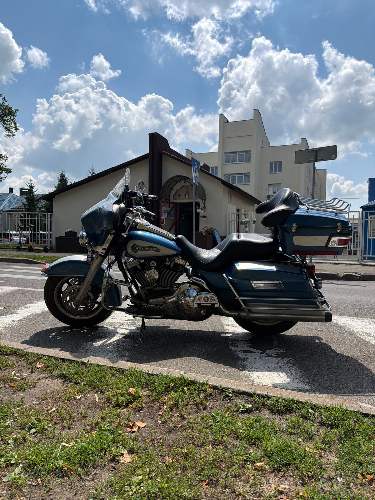 Harley parked, cyclists rolling — a quiet Minsk street corner
