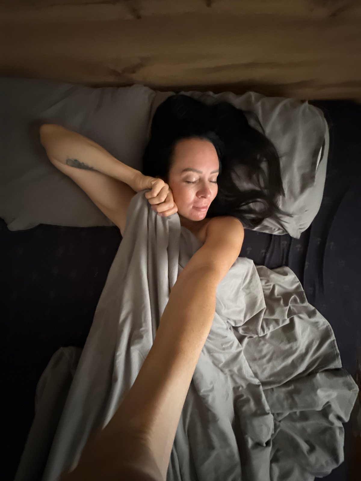 Morning moments: Woman rests while Yorkshire Terrier poses indoors