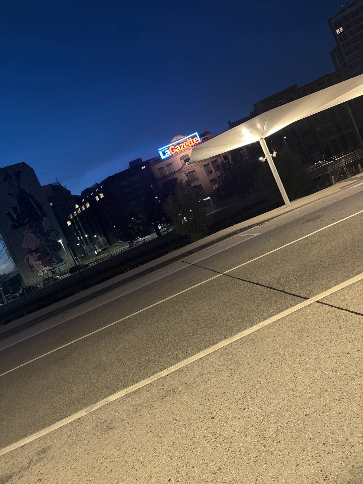 Cartoon mural lights up a Charleroi street at night