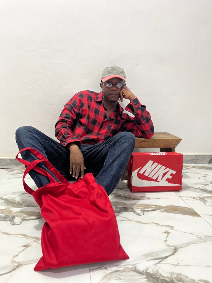 Person conducts photo session with various outfits in Ghana