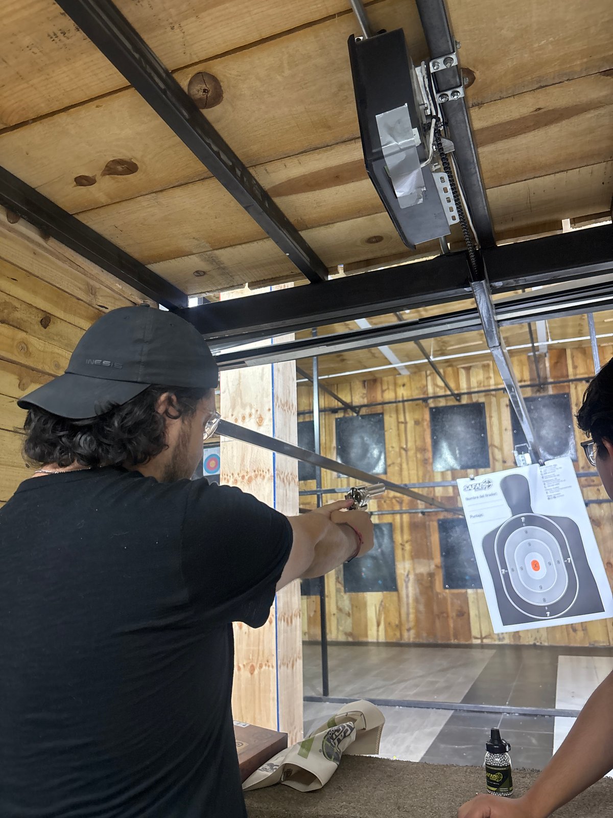 Person practices target shooting at indoor range in Cholula