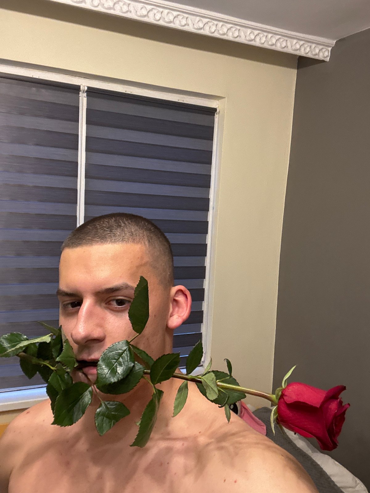 Man poses with flowers indoors in Burgas, Bulgaria