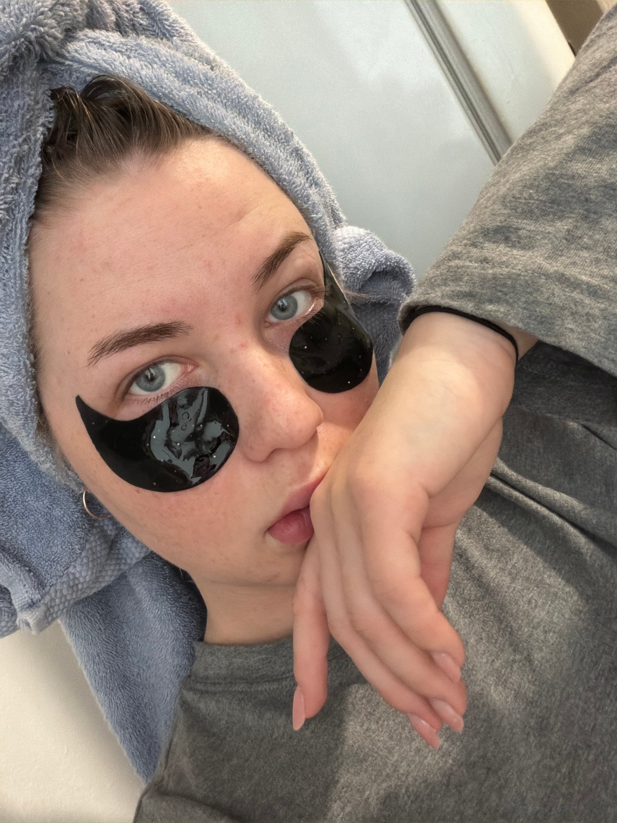 Woman conducts skincare routine with eye patches in Chaikovsky