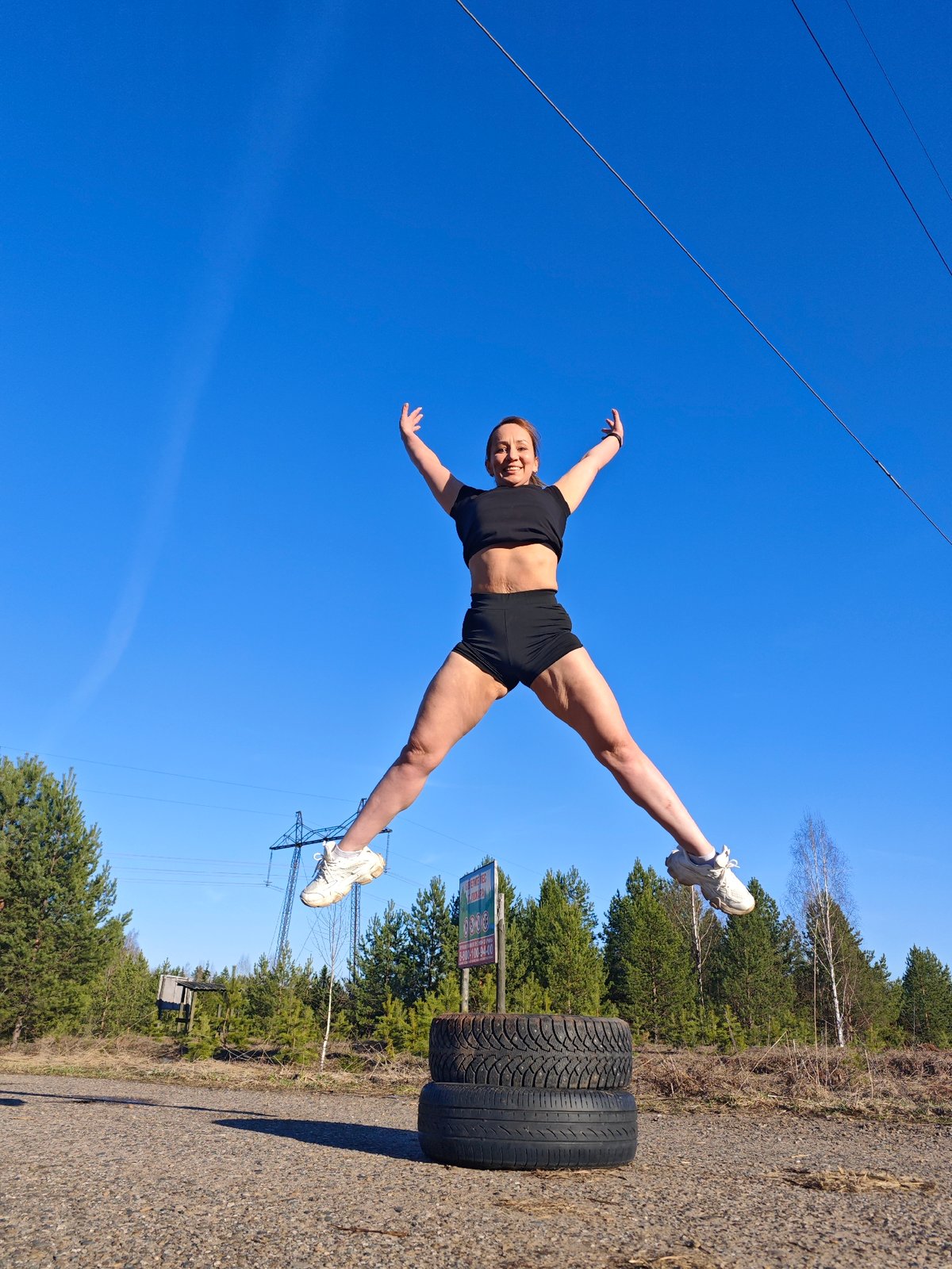 Woman performs tire workout routine in Chaikovsky, Russia