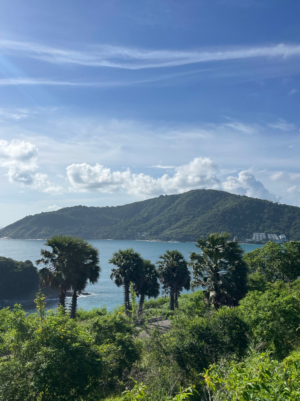 Rawai's green coastal hillside on a clear July morning