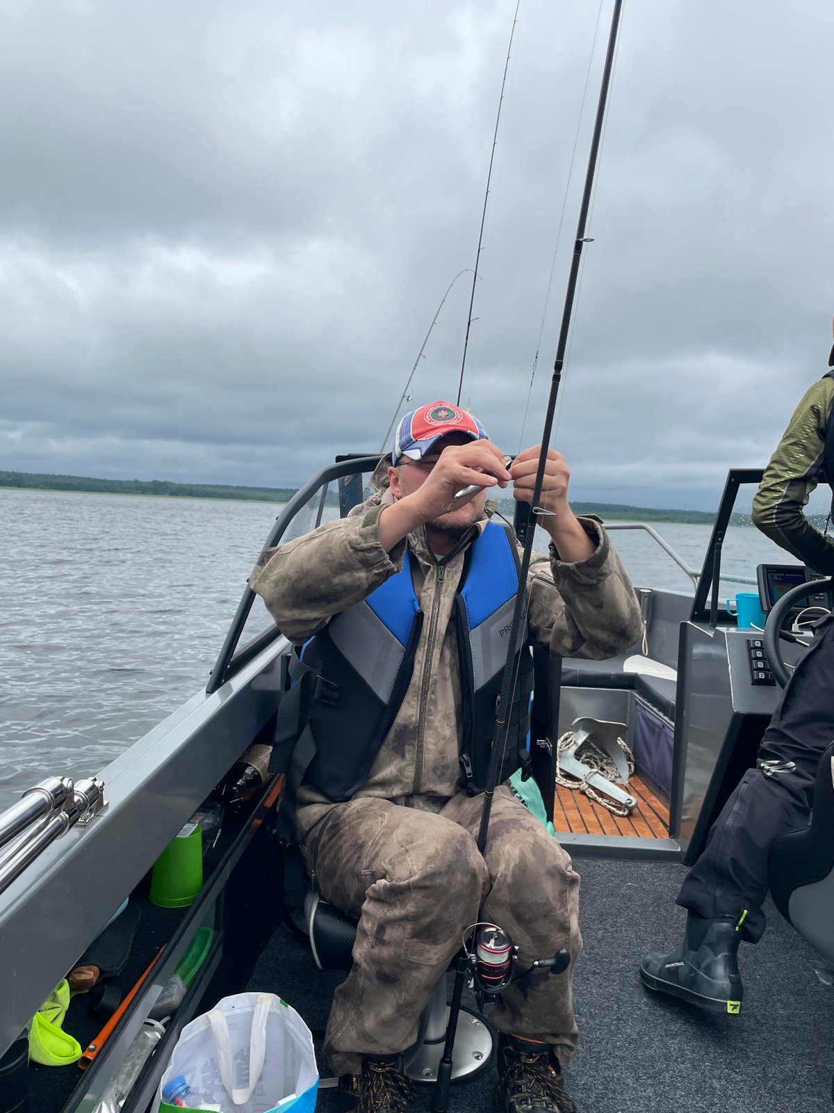 Fishing on a cloudy lake in Yablonovka, Russia