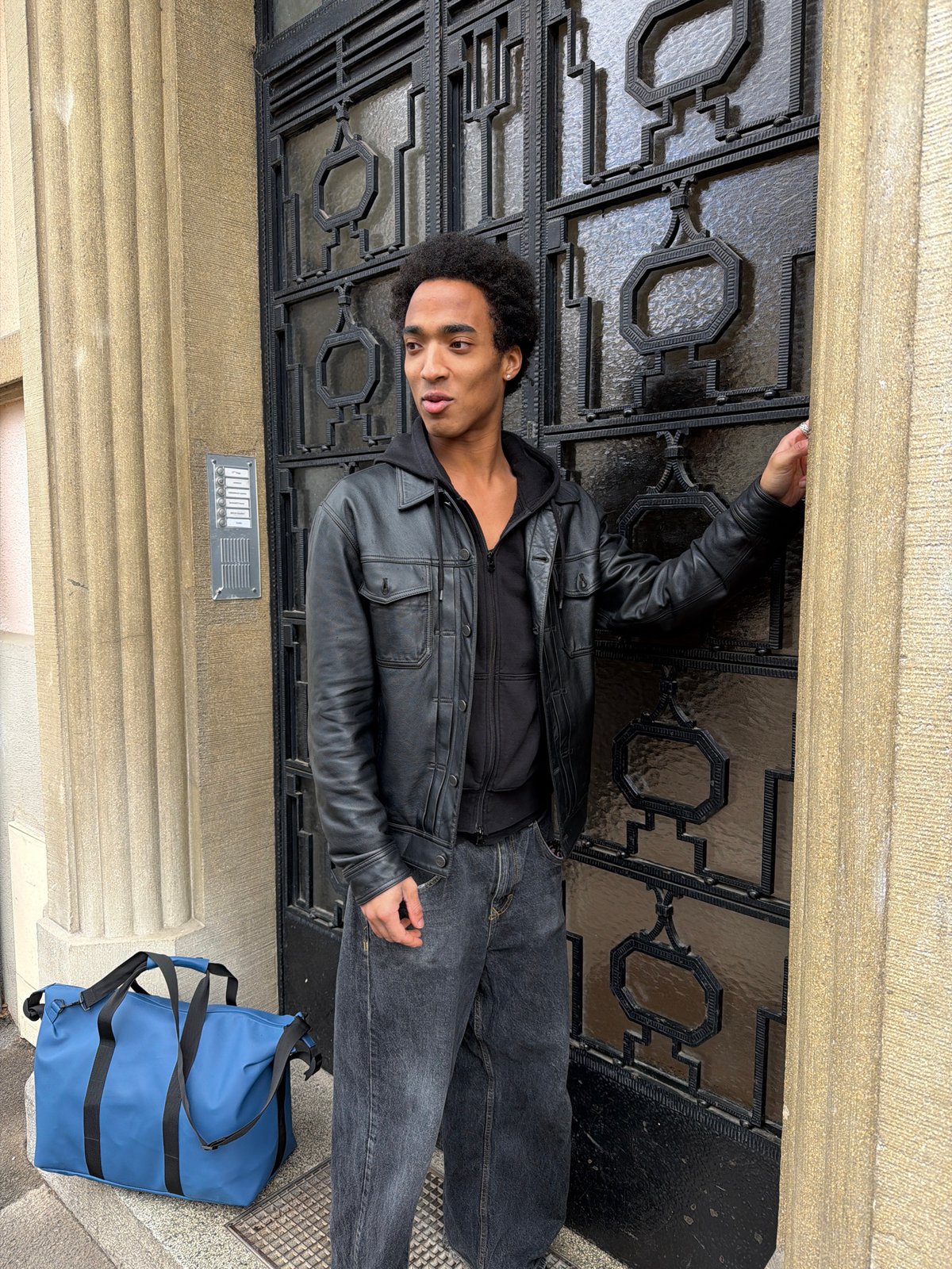 Young man stands outside ornate building in Strasbourg