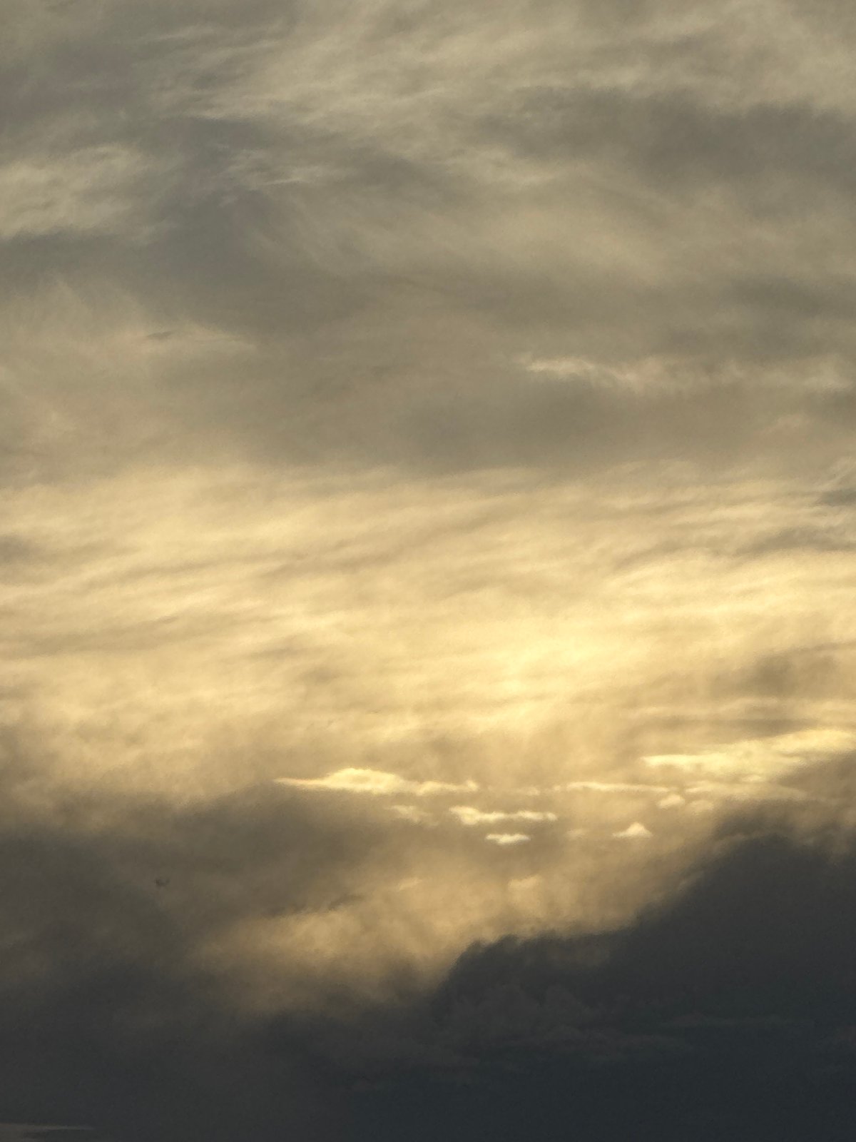 Golden light breaks over misty mountain ranges at dusk