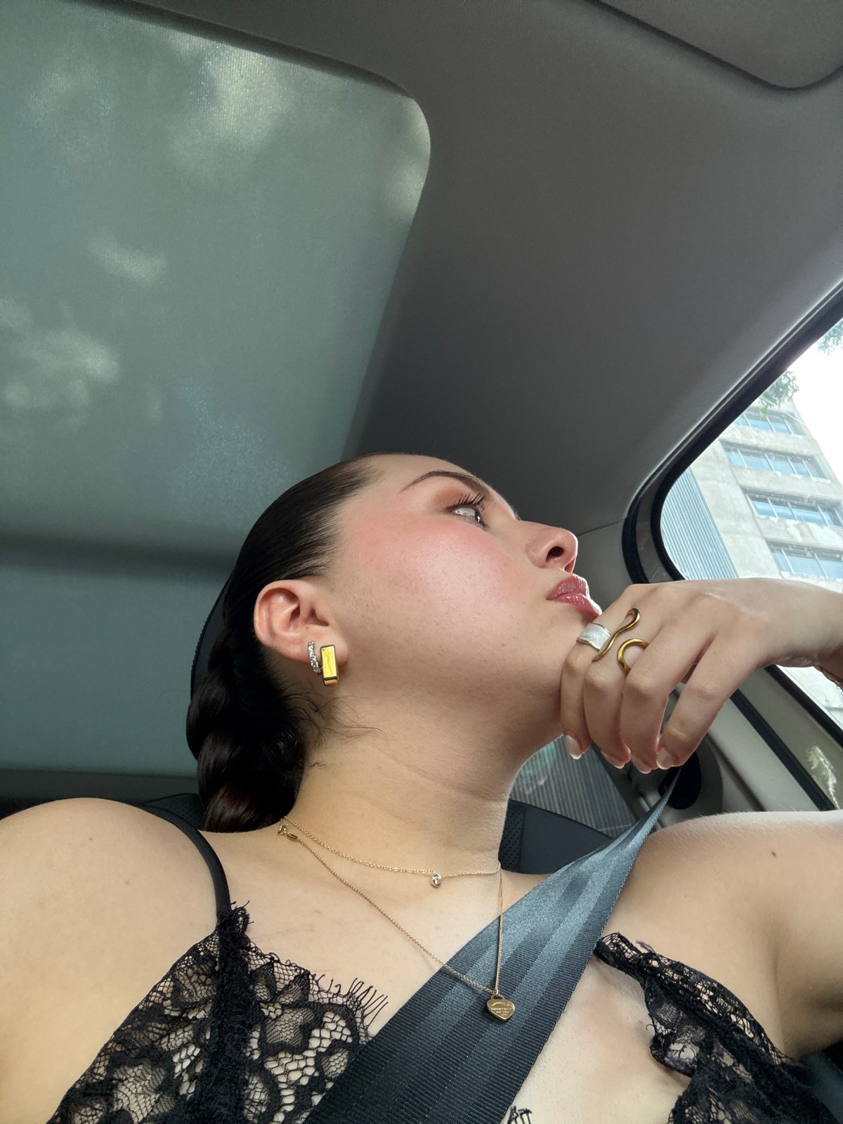 Woman photographed in car during evening drive through Mexico City