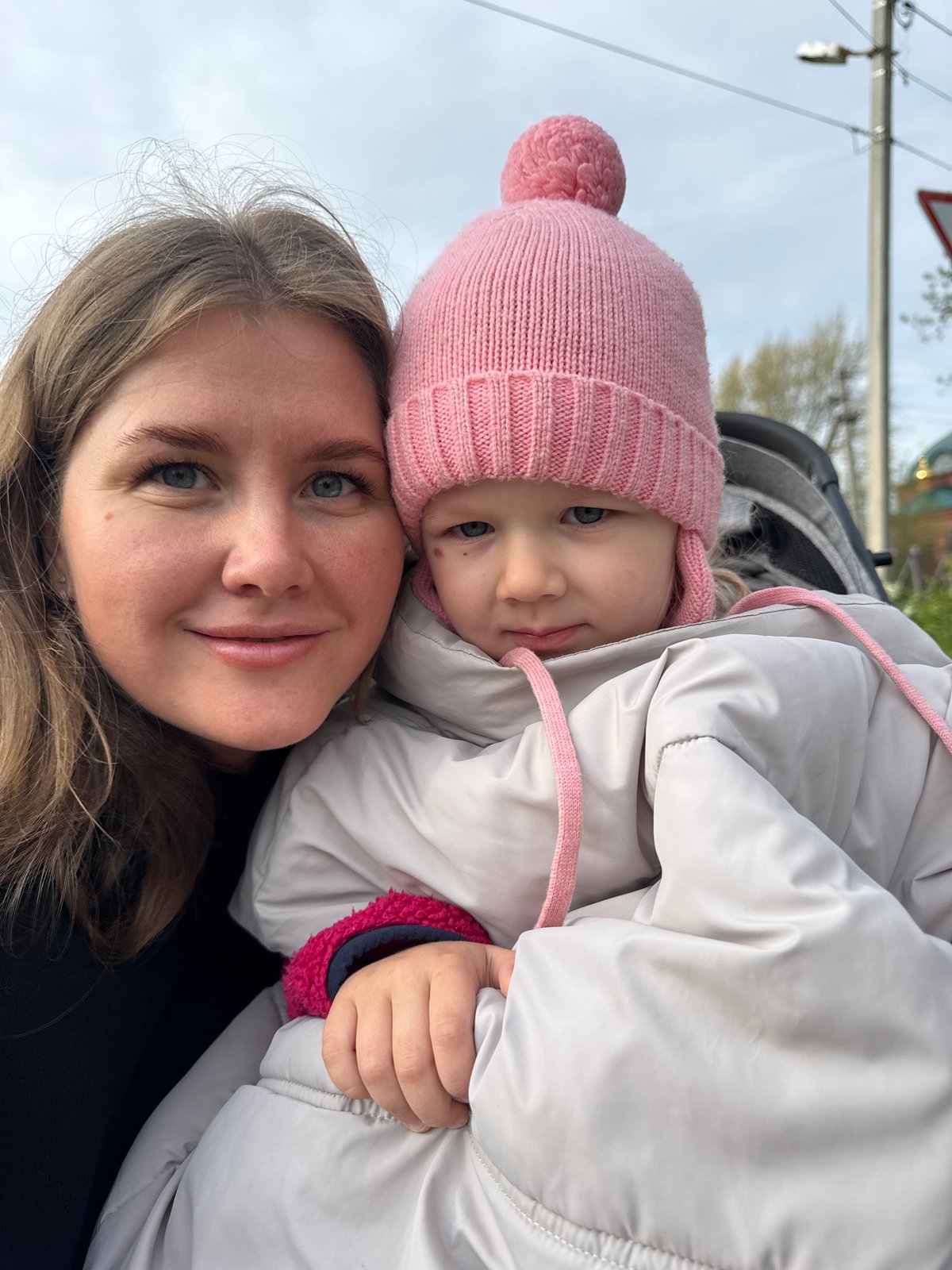 Woman and child stroll through Ферма, Russia early morning