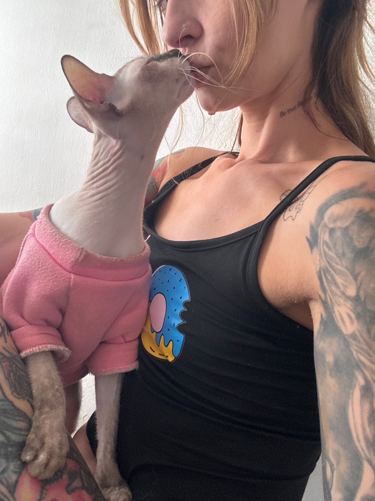 Woman takes selfies with sweater-wearing Sphynx cat in Bat Yam