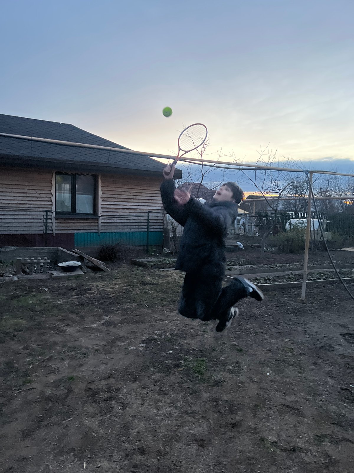 Tennis practice captured at sunset in rural Votkinsk, Russia