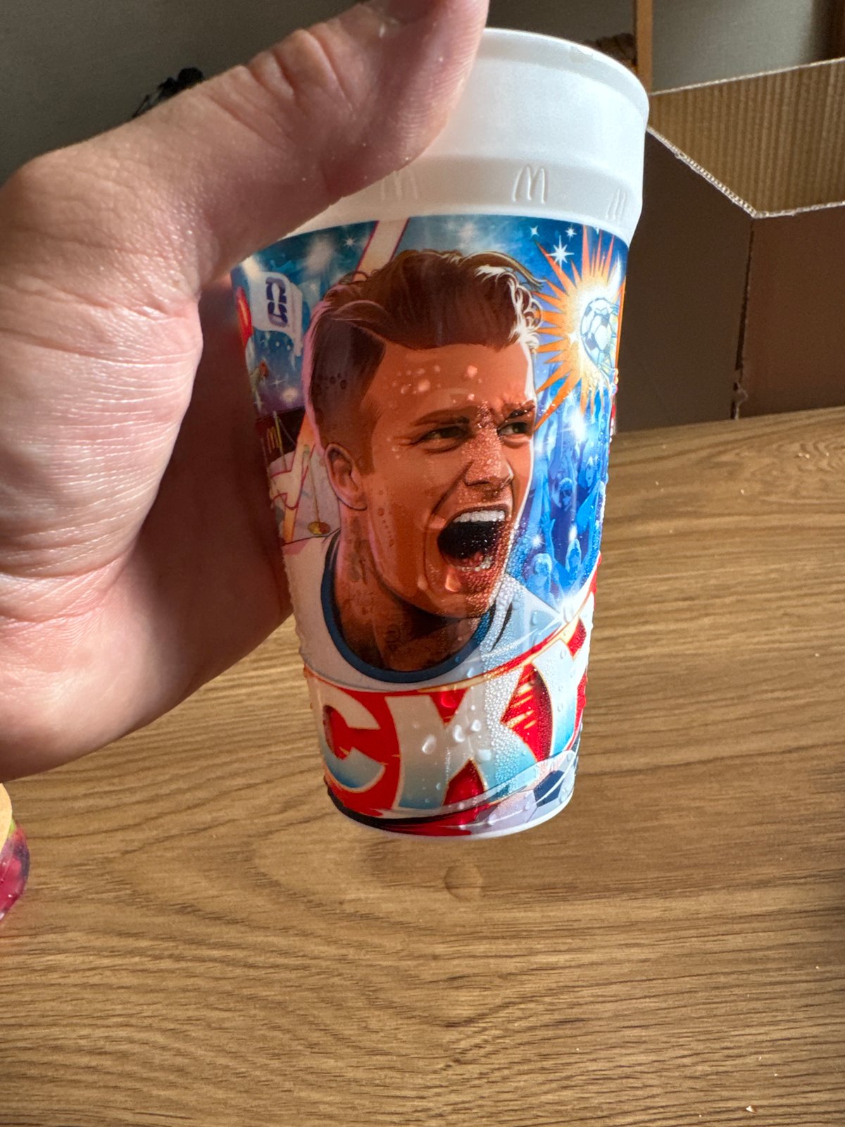 Condensation-covered cup with face print held in Tbilisi