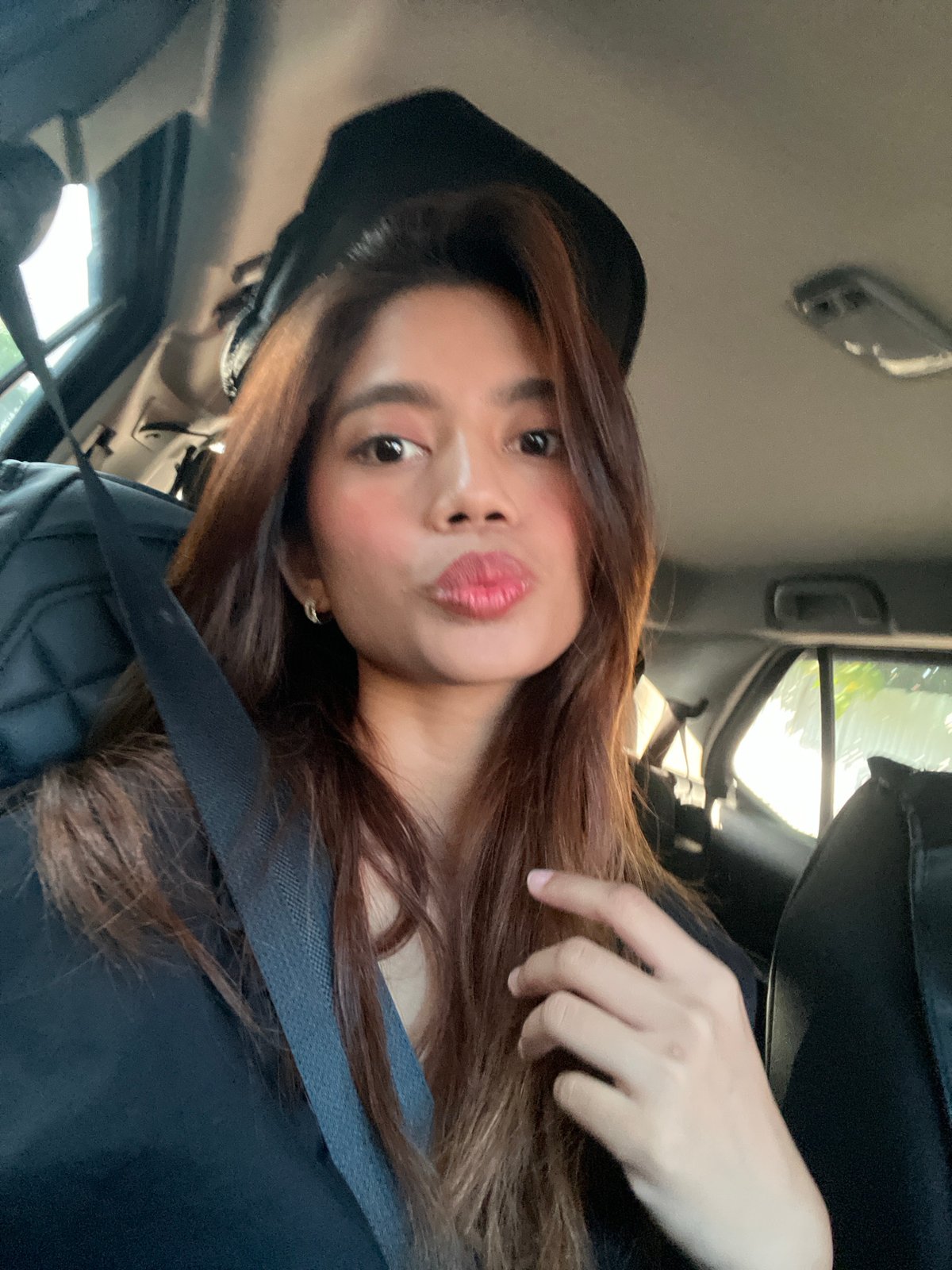 Young woman takes selfies in car, Davao City