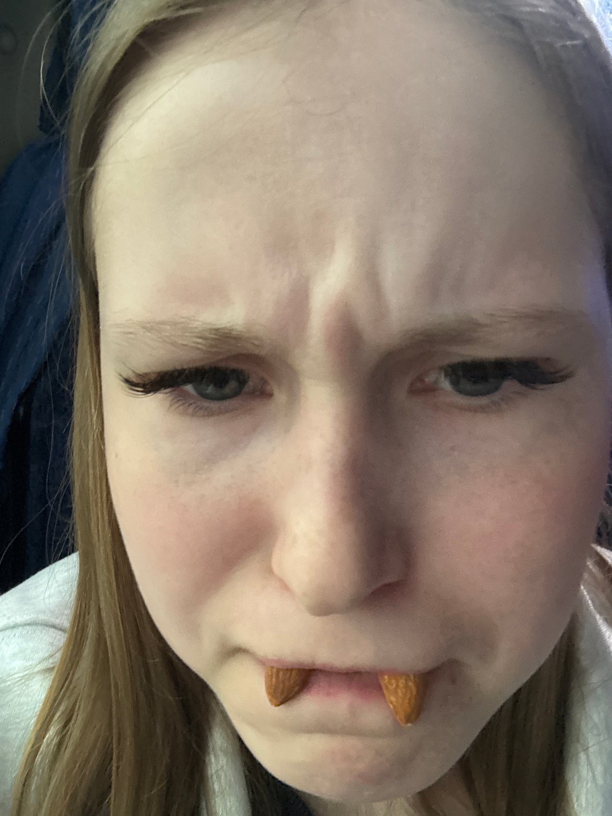 Person poses with almonds as fangs in Russia portrait