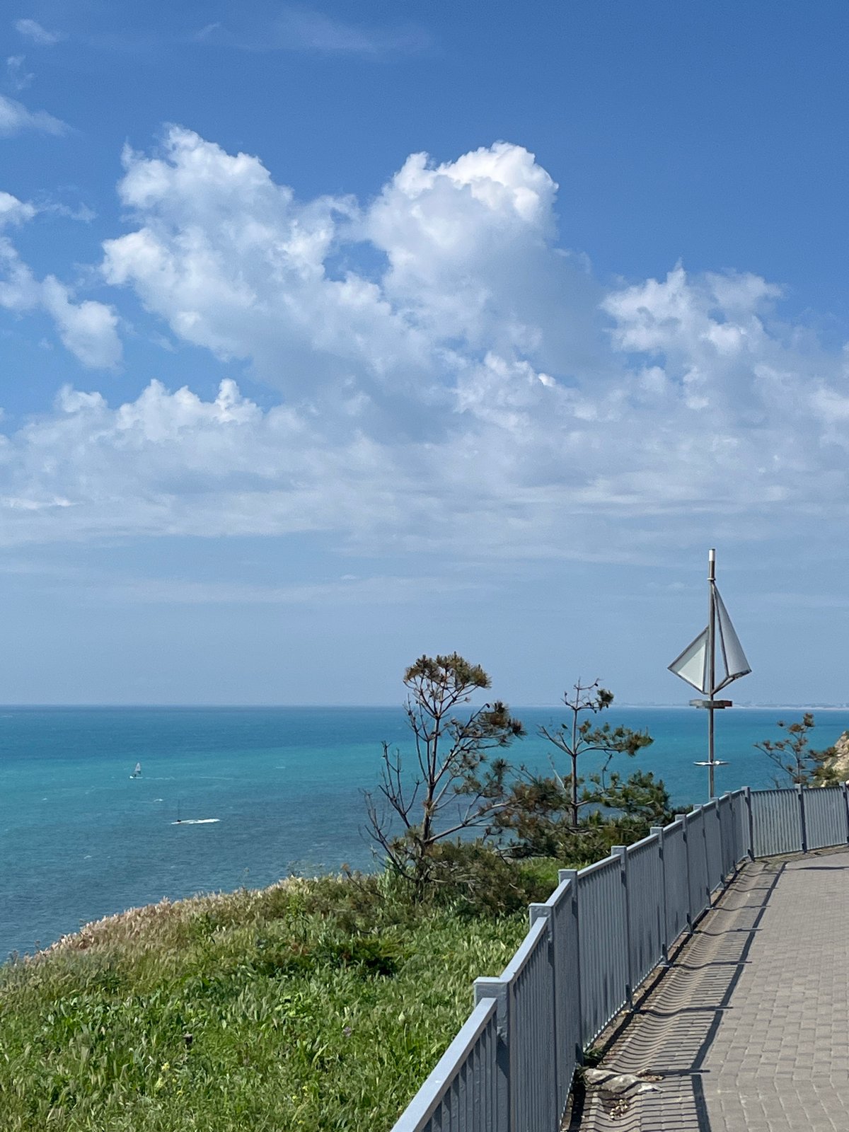 Elderly hiker enjoys sunny morning on Anapa seaside promenade