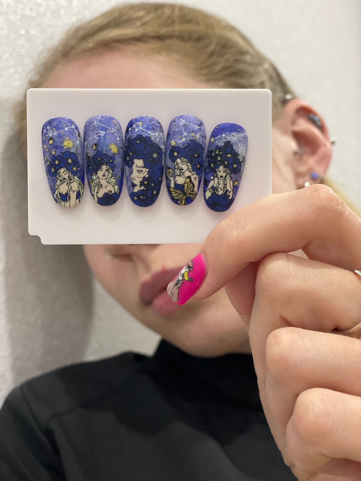 Person displays decorative nail art designs in Izhevsk