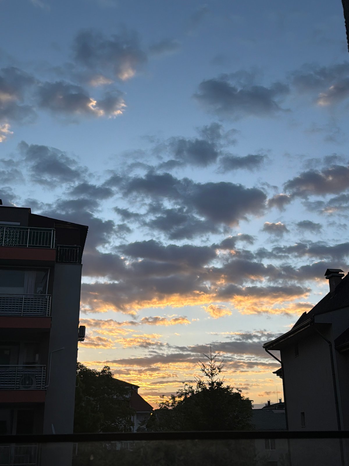 Golden sunset illuminates cloudy skies over Sofia, Bulgaria